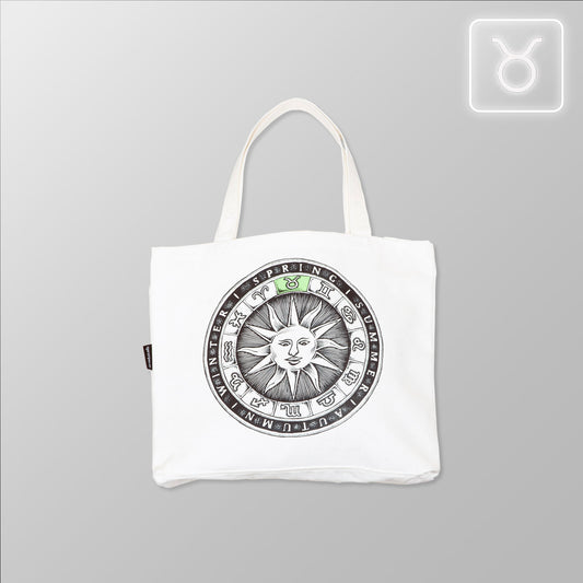 White tote bag with sun design and text on a gray background