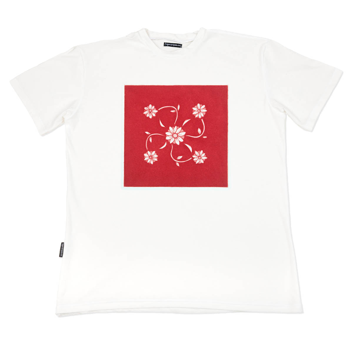 White t-shirt with a red square and floral design on a white background by www.tigerstripes.co
